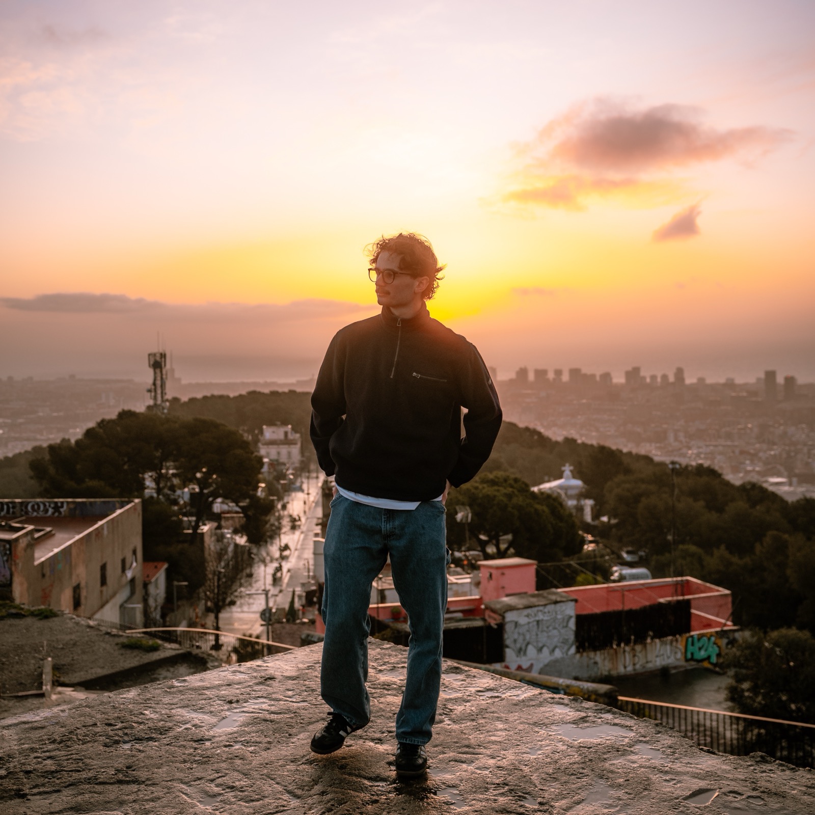 Braden, the photographer behind Lockd Media, overlooking a city at sunset